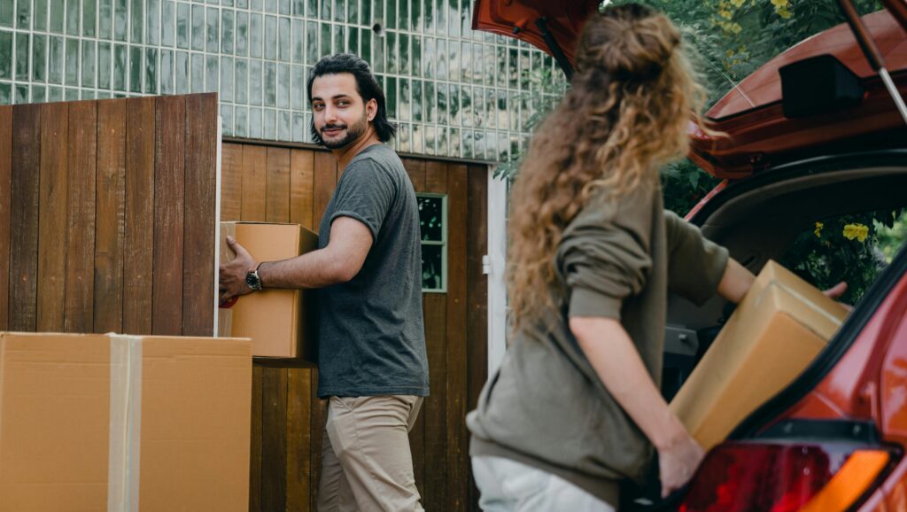 Photo of a couple moving in to their new house.