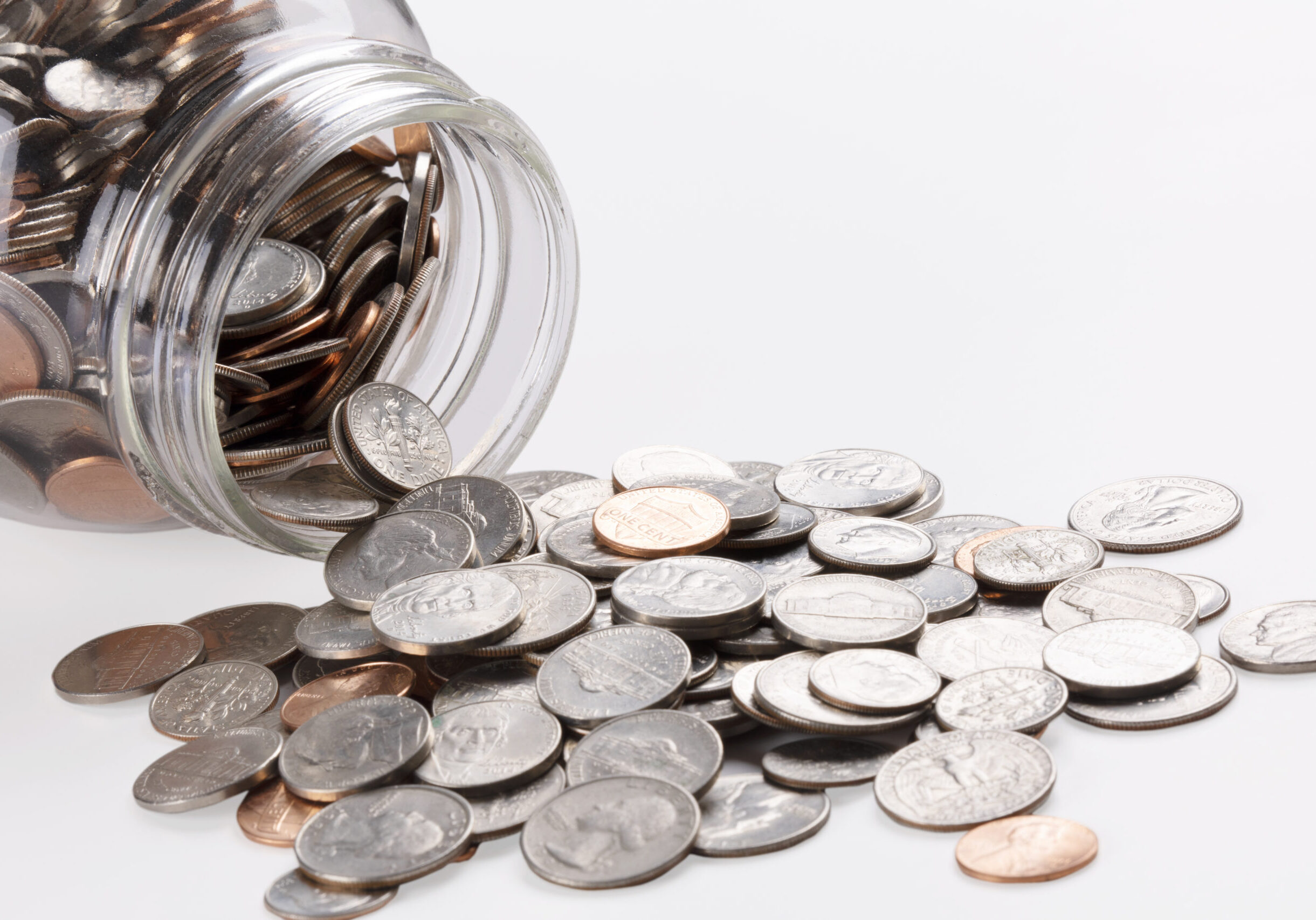 US coins in a jar isolated on white background with copy space