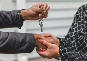 Photo of people exchanging keys